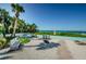 Scenic beach access with benches, palm trees and ocean views, inviting relaxation and enjoyment of the coastal surroundings at 18201 Gulf Blvd # 201, Redington Shores, FL 33708