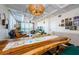 Dining area adjacent to the living room featuring a wooden table, decorative easter decor and overhead lighting fixture at 18201 Gulf Blvd # 201, Redington Shores, FL 33708