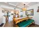 Stylish dining room with wood table, bench seating, and decorative pendant lighting fixture at 18201 Gulf Blvd # 201, Redington Shores, FL 33708