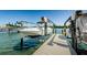 Waterfront dock area with boat lift, offering access to the water at 18201 Gulf Blvd # 201, Redington Shores, FL 33708