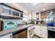 A bright kitchen offering stainless steel appliances, white cabinetry, and a breakfast bar at 18201 Gulf Blvd # 201, Redington Shores, FL 33708