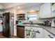 Kitchen featuring stainless steel appliances, white cabinets, and granite countertops at 18201 Gulf Blvd # 201, Redington Shores, FL 33708