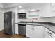This kitchen has white cabinets, stainless steel appliances, and a window above the sink at 18201 Gulf Blvd # 201, Redington Shores, FL 33708