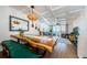 Open-concept living space featuring a unique wooden dining table and comfortable seating with a view of the balcony at 18201 Gulf Blvd # 201, Redington Shores, FL 33708