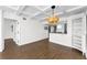The living room boasts a coffered ceiling, wood floors and an open concept to the kitchen at 18201 Gulf Blvd # 201, Redington Shores, FL 33708