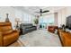 Comfortable living room with stylish furniture, plantation shutters, and seamless access to the balcony with serene water views at 18201 Gulf Blvd # 201, Redington Shores, FL 33708