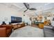 Open-concept living room featuring modern furnishings, a large television, and a unique coffered ceiling design at 18201 Gulf Blvd # 201, Redington Shores, FL 33708