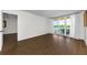 Living room featuring new laminate floors and sliding glass doors that lead to a balcony at 18201 Gulf Blvd # 201, Redington Shores, FL 33708