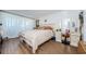 Main bedroom features neutral walls, wood floors, and a vanity/desk area with mirror at 18201 Gulf Blvd # 201, Redington Shores, FL 33708