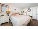 A calming main bedroom featuring wood floors, neutral paint, and classic furnishings at 18201 Gulf Blvd # 201, Redington Shores, FL 33708