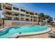 Community pool with lounge chairs at 18201 Gulf Blvd # 201, Redington Shores, FL 33708