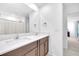 Bathroom features a double vanity with white countertops and dark cabinets at 22223 Storybook Cabin Way, Land O Lakes, FL 34637
