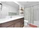 Bathroom with double vanity, white countertop and shower/tub with curtain at 22223 Storybook Cabin Way, Land O Lakes, FL 34637