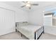 Bedroom with a bed, closet and bright window at 22223 Storybook Cabin Way, Land O Lakes, FL 34637