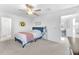 Bright bedroom with plush carpeting, ceiling fan and a cozy blue bed frame at 22223 Storybook Cabin Way, Land O Lakes, FL 34637