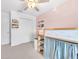The bedroom features a lofted bed with storage, white trim, neutral carpet, and a closet at 22223 Storybook Cabin Way, Land O Lakes, FL 34637