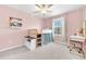 Pink bedroom features a window, a lofted bed with storage, and a charming desk at 22223 Storybook Cabin Way, Land O Lakes, FL 34637