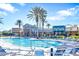 Beautiful community pool with many lounge chairs and clubhouse in the background on a clear day at 22223 Storybook Cabin Way, Land O Lakes, FL 34637