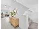 Welcoming entryway leads to the staircase and features modern console table, mirror, and decorative plant at 22223 Storybook Cabin Way, Land O Lakes, FL 34637