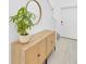 Bright entryway features a modern console table with mirror and a glimpse of the staircase at 22223 Storybook Cabin Way, Land O Lakes, FL 34637