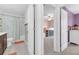 Hallway view into a bathroom with tub/shower and a bedroom with bunk beds at 22223 Storybook Cabin Way, Land O Lakes, FL 34637