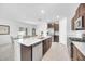 Bright kitchen features stainless appliances, a large island with a sink, and wood cabinets at 22223 Storybook Cabin Way, Land O Lakes, FL 34637