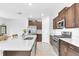 Modern kitchen featuring a large island, stainless steel appliances, and a seamless flow into the dining area at 22223 Storybook Cabin Way, Land O Lakes, FL 34637