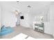 Bright upstairs loft with a ceiling fan, gray cabinet, and a comfortable blue sofa at 22223 Storybook Cabin Way, Land O Lakes, FL 34637