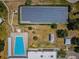 Aerial view showcasing the community pool, solar panels, and surrounding landscape at 2255 Philippine Dr # 21, Clearwater, FL 33763
