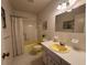 Traditional bathroom with tub, toilet, and vanity sink with neutral tile and decor at 2255 Philippine Dr # 21, Clearwater, FL 33763