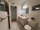 Bright bathroom featuring a tiled shower, updated vanity, and neutral decor at 2255 Philippine Dr # 21, Clearwater, FL 33763