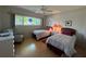 Sunny bedroom with two twin beds, large window, and comfortable armchair at 2255 Philippine Dr # 21, Clearwater, FL 33763