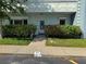 Charming front entrance with lush landscaping, colorful flowers, and a welcoming pathway at 2255 Philippine Dr # 21, Clearwater, FL 33763