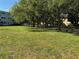 Lush green grassy area with shade trees and sidewalk at 2255 Philippine Dr # 21, Clearwater, FL 33763