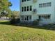 Lovely green condo building with a patio and lush lawn at 2255 Philippine Dr # 21, Clearwater, FL 33763
