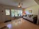 Bright living room with a ceiling fan, large window, and a charming seating arrangement at 2255 Philippine Dr # 21, Clearwater, FL 33763