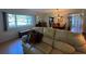 Cozy living room featuring a cream-colored sofa, large window, and a glimpse of the dining area at 2255 Philippine Dr # 21, Clearwater, FL 33763