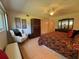 Spacious main bedroom with a comfortable chair, large bed, and ample closet space at 2255 Philippine Dr # 21, Clearwater, FL 33763