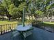 Outdoor patio featuring a table, chairs, and a serene view of the surrounding greenery at 2255 Philippine Dr # 21, Clearwater, FL 33763