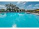 Large sparkling blue community pool with seating and umbrellas, ideal for relaxing and recreation at 2255 Philippine Dr # 21, Clearwater, FL 33763