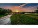 Beautiful waterfront with a sunset view, a wooden path to the lake, and lush green space at 2255 Philippine Dr # 21, Clearwater, FL 33763