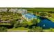 Scenic aerial view of the condos showing serene water features, a golf course, and convenient parking at 2323 Feather Sound Dr # F101, Clearwater, FL 33762
