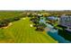 Expansive aerial shot featuring lush fairways and waterfront residences, set against a backdrop of scenic beauty at 2323 Feather Sound Dr # F101, Clearwater, FL 33762