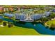 Impressive aerial perspective showcasing residences along a waterfront, coupled with verdant golf course scenery at 2323 Feather Sound Dr # F101, Clearwater, FL 33762