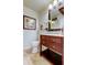 Cozy bathroom features a wood vanity with drawers and a framed mirror at 2323 Feather Sound Dr # F101, Clearwater, FL 33762