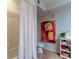 Bathroom showcasing a white shower curtain, modern art, and a sleek white toilet at 2323 Feather Sound Dr # F101, Clearwater, FL 33762