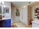 Bright bathroom with tile flooring, shower with white curtain, vanity, and decorative plants at 2323 Feather Sound Dr # F101, Clearwater, FL 33762