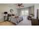 Comfortable bedroom with a ceiling fan, a cozy bed, and access to a balcony at 2323 Feather Sound Dr # F101, Clearwater, FL 33762