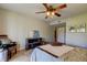 Bright bedroom offering neutral walls, decorative art, and a ceiling fan at 2323 Feather Sound Dr # F101, Clearwater, FL 33762