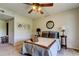 Bedroom with a ceiling fan, neutral walls, decorative art, and a comfortable bed at 2323 Feather Sound Dr # F101, Clearwater, FL 33762